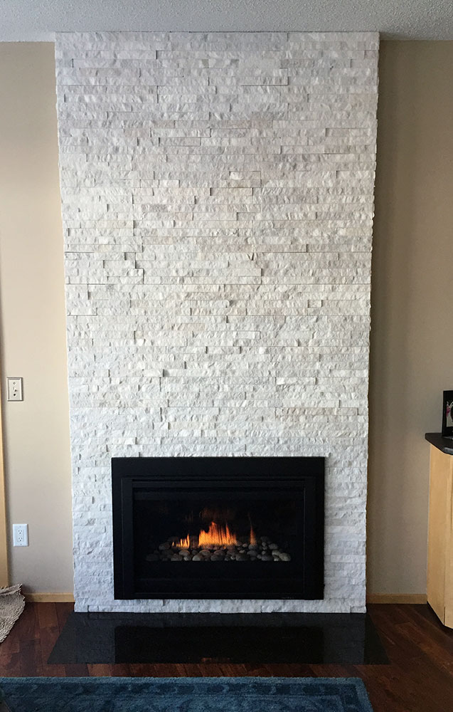 Modern white stone fireplaces built by Carter Custom Construction, your trusted builder for fireplaces and more.