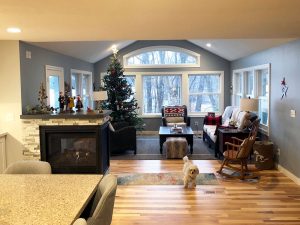 home-remodel-3-way-fireplace_twin-cities_mn Living room remodel with 3 sided fireplace in between open floor plan kitchen and living room, built by Kitchen remodel with open shelving and white cabinets, by Carter Custom Construction