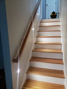 home-remodel-stair-lighting_twin-cities_mn Basement stairway with low, custom lighting for the stairs, built by Kitchen remodel with open shelving and white cabinets, by Carter Custom Construction