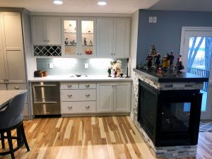 kitchen-remodel-fireplace-3-sided_lakevilled_mn Kitchen remodeling project with white cabinets and a pale blue/green backsplash, and a 3-sided fireplace, all built by Carter Custom Construction