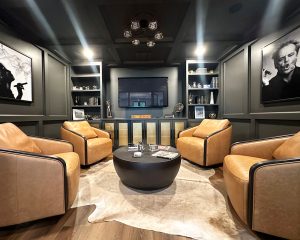 home-remodelers-cigar-room_custom-construction_twin-cities High end, sophisticated looking room that was remodeled into a cigar room and has dark gray walls with framed pieces and large leather chairs, remodeled by Carter Custom Construction
