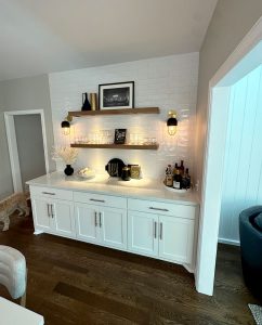 main-level-bar-custom-remodel_st-paul Dry bar along kitchen wall with white tile on the wall and floating shelves with built-in lighting, remodeled by Carter Custom Construction