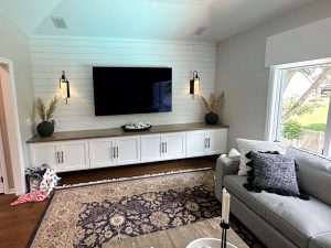main-level-living-area-custom-remodel_woodbury_mn Modern living room remodel with white shiplap statement wall behind the TV with built in shelves, built by Carter Custom Construction